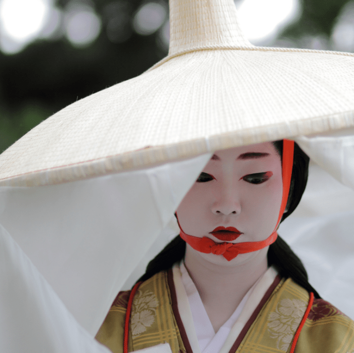 芸妓 尚可寿さん Kyoto, Japan. The geiko (geisha) Naokazu dressed as the 13th century writer Madame Fujiwara-Tameie (Abutsu Ni) in the Jidai Matsuri, one of the three big festivals of Kyoto. Over 2,000 people, including many geiko (geisha) and maiko (apprentice geisha), wore costumes representing various eras of Kyoto's 1,200-year history as they paraded through the city. Kyoto was the capital of Japan from 794 until 1868. It is now the seventh largest city in Japan. In Kyoto geisha are known as geiko and trainee geisha are known as maiko.